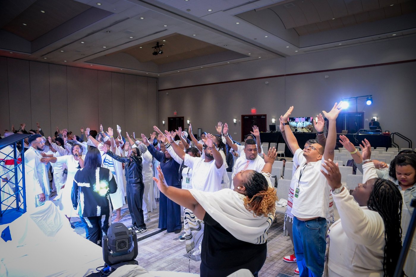 Power Surge encounter moment: attendees with hands lifted in worship